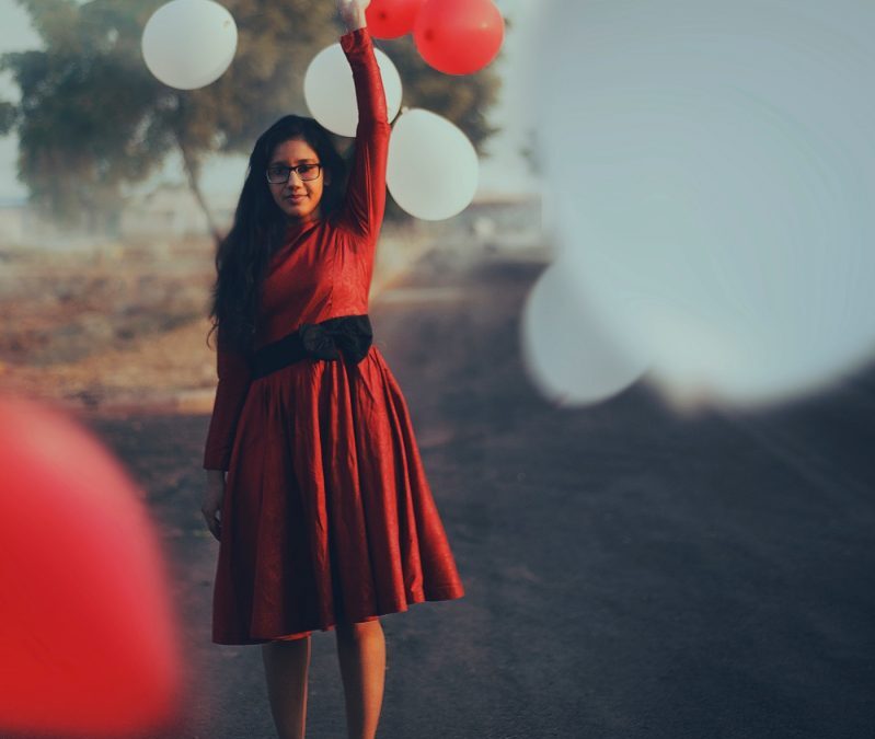 woman releasing balloons